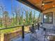 Outdoor balcony with railing, patio furniture, and wooded views at 914 Laurel Creek Ln, Charlotte, NC 28211