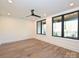 Bright basement with sleek wood floors, large windows, and a modern ceiling fan at 914 Laurel Creek Ln, Charlotte, NC 28211