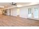 Open basement layout boasts light wood floors, modern lighting, and seamless transition to outdoor patio at 914 Laurel Creek Ln, Charlotte, NC 28211