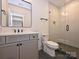 Modern bathroom features double sinks, sleek vanity, and glass-enclosed shower with tiled walls at 914 Laurel Creek Ln, Charlotte, NC 28211