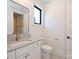Modern bathroom features grey vanity with gold fixtures and tiled floor at 914 Laurel Creek Ln, Charlotte, NC 28211
