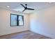 A bright bedroom with black ceiling fan and modern, black-framed window at 914 Laurel Creek Ln, Charlotte, NC 28211
