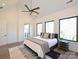 Spacious bedroom with large windows, hardwood floors, and a tray ceiling at 914 Laurel Creek Ln, Charlotte, NC 28211