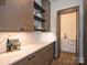 Convenient butler's pantry with modern cabinets, marble counters, and view of wine fridge at 914 Laurel Creek Ln, Charlotte, NC 28211