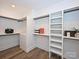 Walk-in closet features custom shelving, storage and hardwood flooring at 914 Laurel Creek Ln, Charlotte, NC 28211