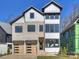 Stunning two-story home featuring a stone facade and modern wood garage doors at 914 Laurel Creek Ln, Charlotte, NC 28211