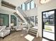 Bright foyer with high ceilings, large windows, and a modern floating staircase at 914 Laurel Creek Ln, Charlotte, NC 28211