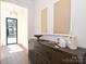 Hallway features a wooden console table with decorative vases and artwork at 914 Laurel Creek Ln, Charlotte, NC 28211