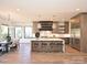Bright, open kitchen with modern island, stainless steel fridge, and marble countertops at 914 Laurel Creek Ln, Charlotte, NC 28211