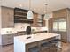 Beautiful kitchen featuring stainless steel appliances, marble countertops and island seating at 914 Laurel Creek Ln, Charlotte, NC 28211