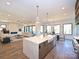 Open concept kitchen with an island, dining space, and living room with a fireplace at 914 Laurel Creek Ln, Charlotte, NC 28211