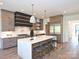 Spacious kitchen with stainless steel appliances, a large island, and modern pendant lighting at 914 Laurel Creek Ln, Charlotte, NC 28211