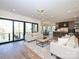 Open concept living room leading into kitchen and dining area with large windows at 914 Laurel Creek Ln, Charlotte, NC 28211