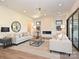 Spacious living room with fireplace, modern lighting, and ample seating at 914 Laurel Creek Ln, Charlotte, NC 28211