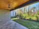 A covered patio featuring stone floors, a wood plank ceiling, and a ceiling fan at 914 Laurel Creek Ln, Charlotte, NC 28211