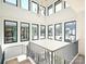 Bright staircase features multiple windows, black metal railings, and stylish pendant lighting at 914 Laurel Creek Ln, Charlotte, NC 28211
