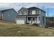 Charming two-story home with gray siding, a white garage door, and a welcoming front porch at 117 High Rock Ct # 09, Statesville, NC 28677