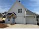 Charming new construction home with a light blue door, two-car garage, and modern farmhouse details at 4314 Morning Mist Dr # 15, Sherrills Ford, NC 28673