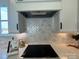 Countertop with cooktop, white herringbone backsplash, and ample upper cabinetry at 4314 Morning Mist Dr # 15, Sherrills Ford, NC 28673