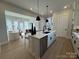Kitchen island with barstool seating, stainless steel dishwasher, and sink with black faucet at 4314 Morning Mist Dr # 15, Sherrills Ford, NC 28673