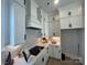 White kitchen featuring herringbone backsplash, ample cabinetry, modern hardware, and updated appliances at 4314 Morning Mist Dr # 15, Sherrills Ford, NC 28673