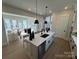 Spacious island with modern sink and faucet, stainless steel dishwasher, and view into the living room at 4314 Morning Mist Dr # 15, Sherrills Ford, NC 28673