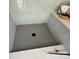 Close-up of shower featuring mosaic tile floor, built-in bench, and marble-look walls at 4314 Morning Mist Dr # 15, Sherrills Ford, NC 28673