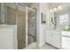 This bathroom offers a standing glass shower, tiled floors, and a bright white vanity at 1015 Kokomo Ln # 22, Charlotte, NC 28206
