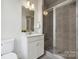 This bathroom offers a clean white vanity and tiled shower with glass doors at 1015 Kokomo Ln # 22, Charlotte, NC 28206