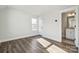 This bedroom provides an en suite bathroom, light-filled living space, and wood floors at 1015 Kokomo Ln # 22, Charlotte, NC 28206