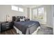 This bedroom features large windows, dark gray nightstands, and a modern design at 1015 Kokomo Ln # 22, Charlotte, NC 28206