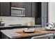 Modern kitchen features stainless steel appliances, gray cabinets, white subway tile backsplash and speckled gray countertops at 1015 Kokomo Ln # 22, Charlotte, NC 28206