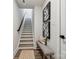 Inviting stairway with decorative art, light wood treads, and modern design at 1015 Kokomo Ln # 22, Charlotte, NC 28206