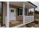 Charming front porch with white railing and new flooring at 317 Blackburn St # 4, York, SC 29745