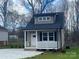 Charming home featuring a covered porch, light siding, and a well-manicured lawn at 317 Blackburn St, York, SC 29745