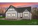 Stunning modern farmhouse exterior with white siding, stone accents, and a landscaped lawn at 179 Heartland Dr # 8, Rock Hill, SC 29732
