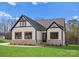 White farmhouse exterior with stone accents and a two-car garage at 179 Heartland Dr # 8, Rock Hill, SC 29732