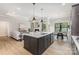 Modern kitchen island featuring barstool seating, stylish pendant lighting and stainless steel appliances at 179 Heartland Dr # 8, Rock Hill, SC 29732