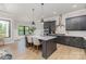 Open kitchen with island, modern stainless steel appliances, and hardwood flooring at 179 Heartland Dr # 8, Rock Hill, SC 29732