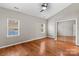 Bright bedroom with hardwood floors and a mirrored closet at 286 Glencoe Ln, Mooresville, NC 28117
