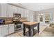 Eat-in kitchen with island, stainless steel appliances, and white cabinets at 286 Glencoe Ln, Mooresville, NC 28117