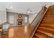 Living room with hardwood floors, a stone fireplace, and staircase at 286 Glencoe Ln, Mooresville, NC 28117