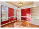 Home office with red walls, built-in shelves, and hardwood floors at 286 Glencoe Ln, Mooresville, NC 28117