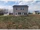 Exterior rear view of house with light gray siding, and door accessing backyard at 169 Salem Springs Ln, Statesville, NC 28625