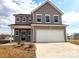 Two-story home featuring a two-car garage, black door, and gray siding at 169 Salem Springs Ln, Statesville, NC 28625