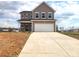 Two-story home featuring a two-car garage, black door, and gray siding at 169 Salem Springs Ln, Statesville, NC 28625