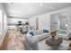 Bright, open-concept living space with white furniture flowing into the dining and kitchen areas at 169 Salem Springs Ln, Statesville, NC 28625