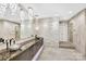 Spa-like bathroom with double vanity, stone feature wall, and large shower at 435 S Tryon St # 800, Charlotte, NC 28202