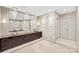 Elegant bathroom with double vanity, stone wall, and chandelier at 435 S Tryon St # 800, Charlotte, NC 28202