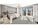 Main bedroom with plush bed, city views, and private balcony access at 435 S Tryon St # 800, Charlotte, NC 28202